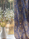 A sheer curtain panel featuring a repeating pattern of ornate golden owls surrounded by delicate floral designs and botanical elements on a deep navy background. The fabric has a fine linen-like texture with translucent qualities.
